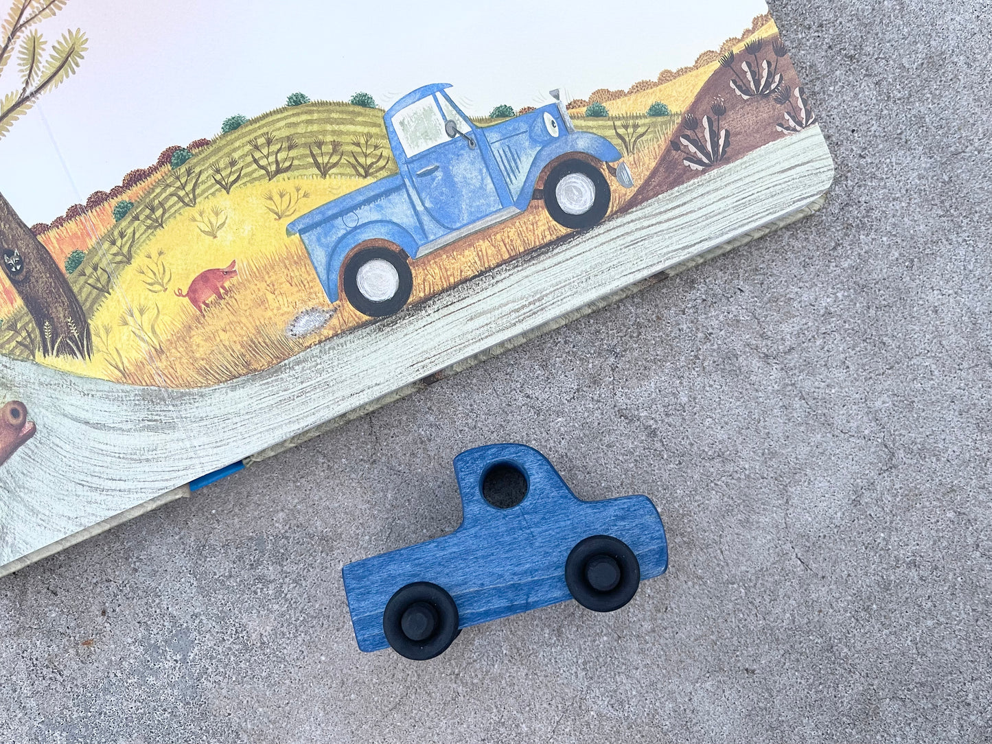 The LITTLE BLUE TRUCK maple wood nontoxic stained rolling mini truck