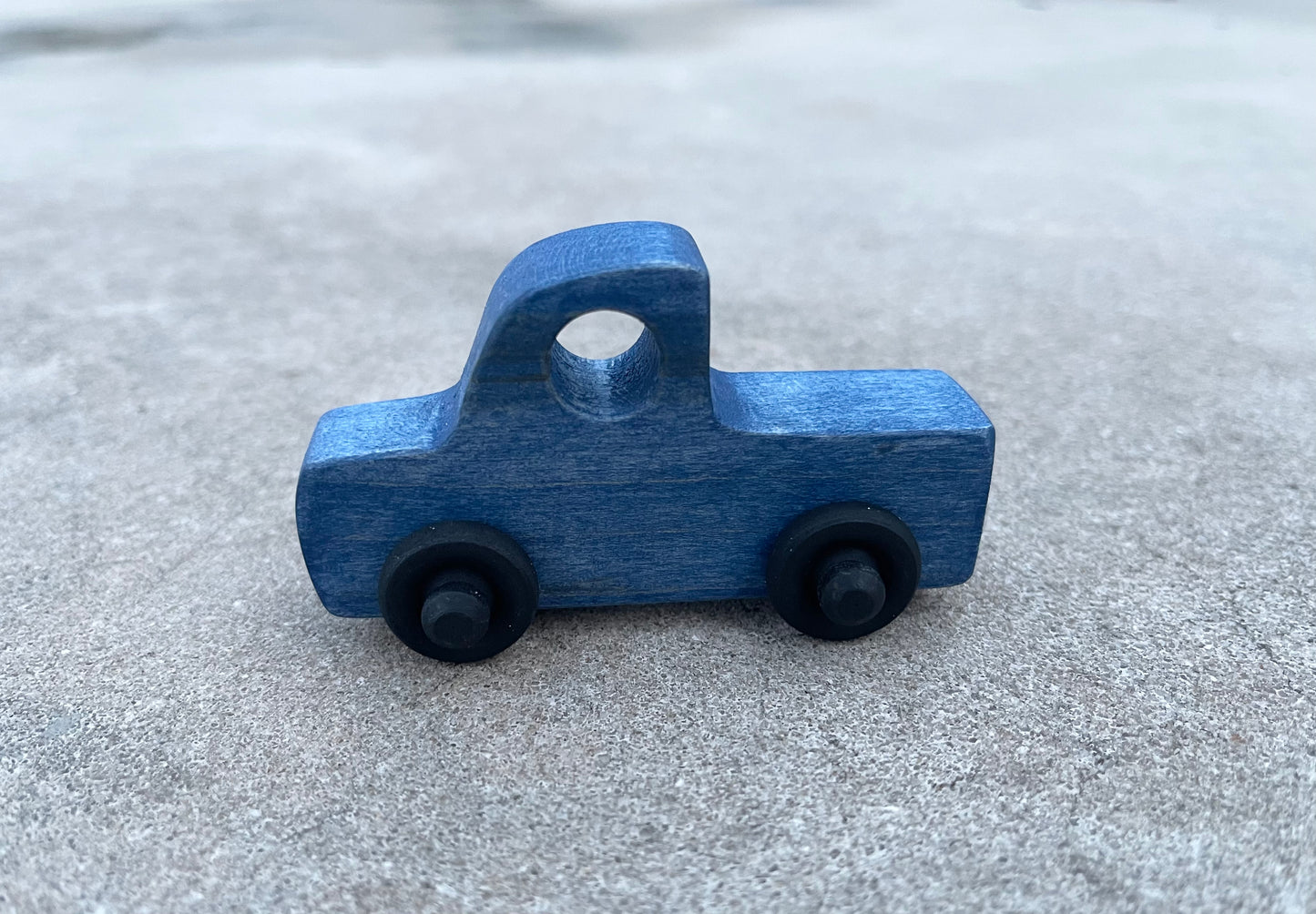 The LITTLE BLUE TRUCK maple wood nontoxic stained rolling mini truck